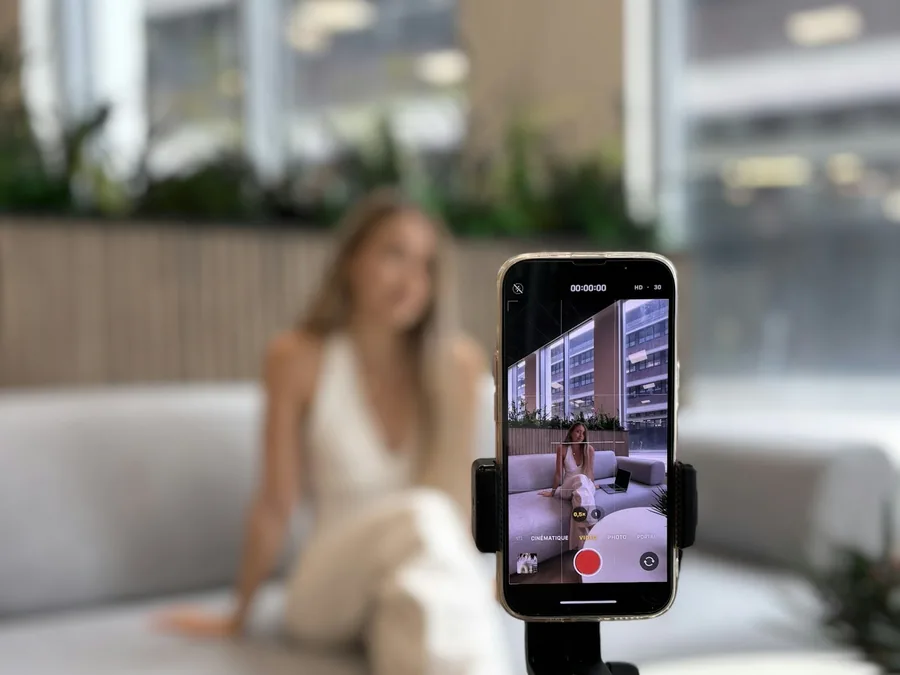 A creator recording herself on a phone tripod