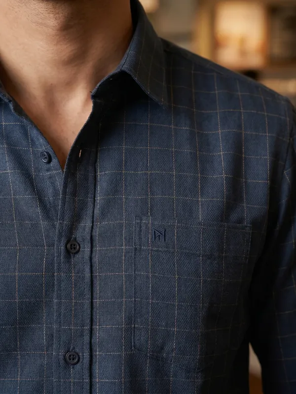 A detail frame: the collar, placket and chest pocket on the body.